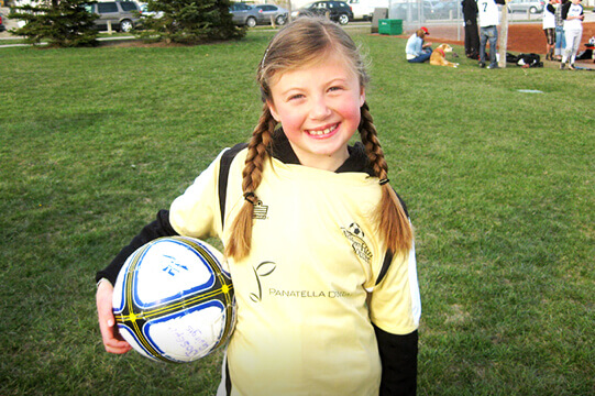 Young teenager holding a football